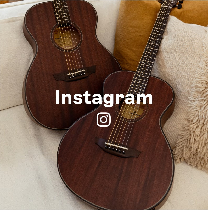 Two mahogany guitars on a sofa with Instagram text and logo overlaid
